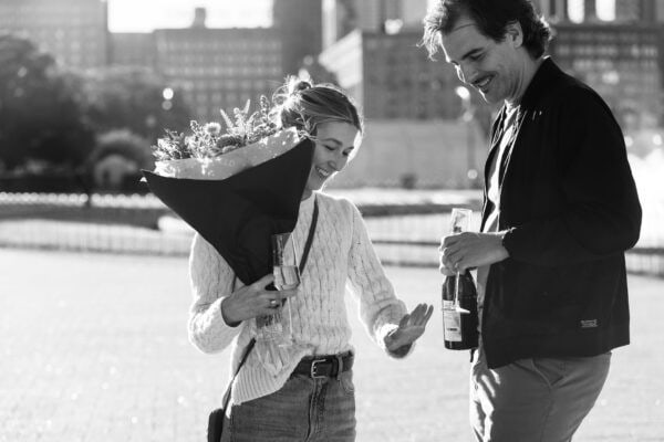 Couple looks at the ring on the finger of the newly engaged
