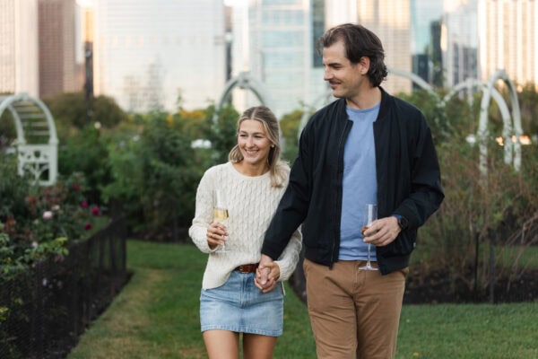 Newly engaged couple walks in the rose garden at the Chicago Buckingham Fountain