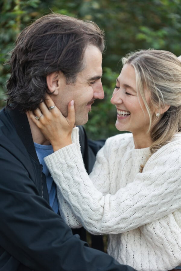 couple poses for an engagement photo after just having a surprise proposal