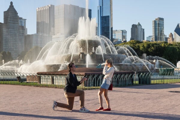 Man proposes to his girlfriend down on one knee at the Buckingham Fountain in Chicago