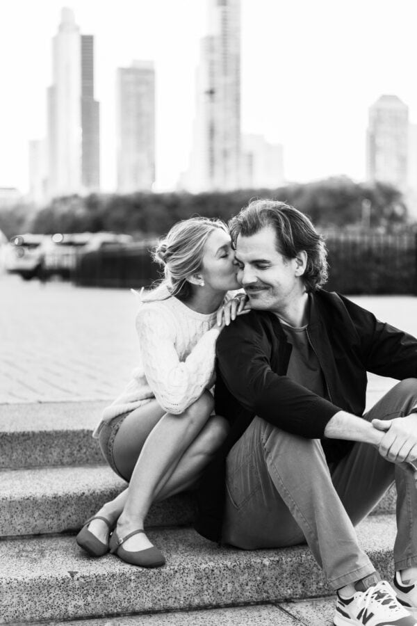 couple poses for an engagement photo after just having a surprise proposal in front of Chicagos skyline