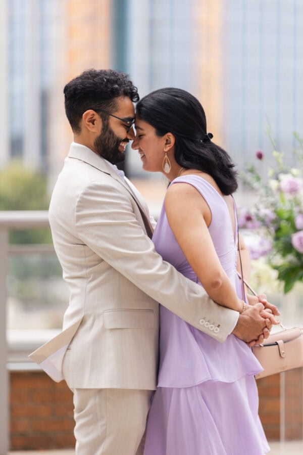 a couple embraces just moments after getting engaged on a rooftop in chicago