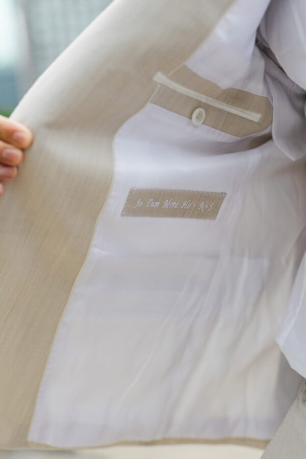 a macro view shows an inscription inside a suit jacket that reads Jo Tum Mere Ho