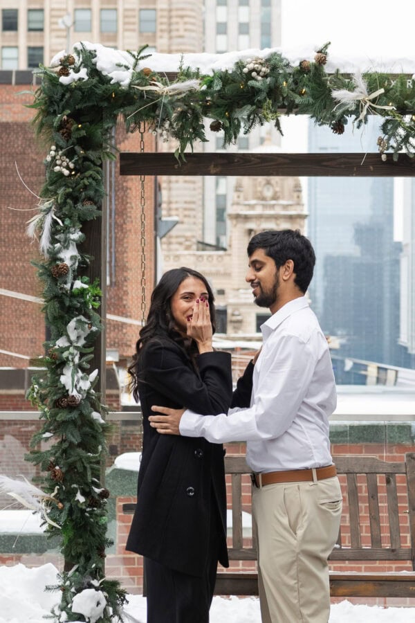 a women shows shock after being proposed to on the rooftop of the Pendry in Chicago in the winter