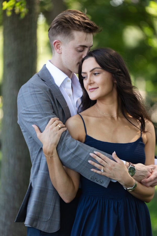 a man wraps his arms around his girlfriend in an embrace