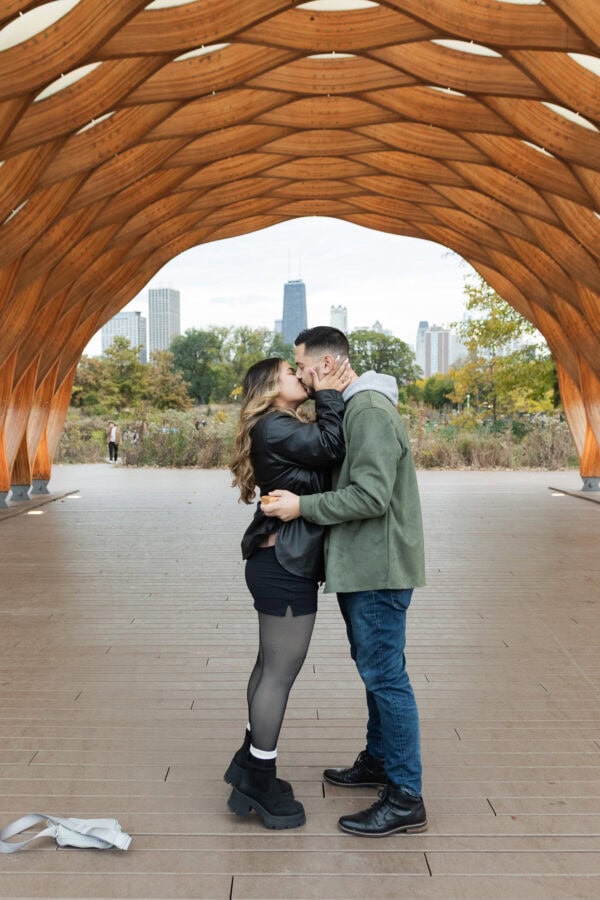 A couple shares a kiss after getting engaged at the Honeycomb in Chicago's Lincoln Park Zoo