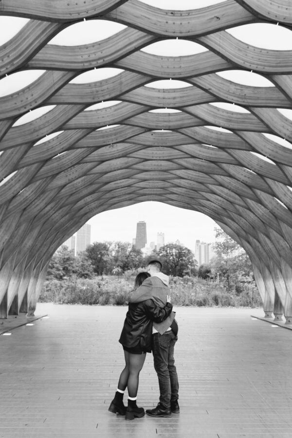 A couple shares a hug after getting engaged at the Honeycomb in Chicago's Lincoln Park Zoo