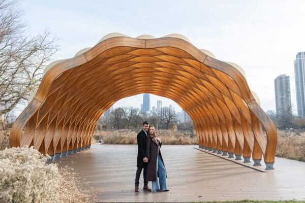 Couple poses for a photo during an engagement session at Peoples Gas Pavilion in Chicago