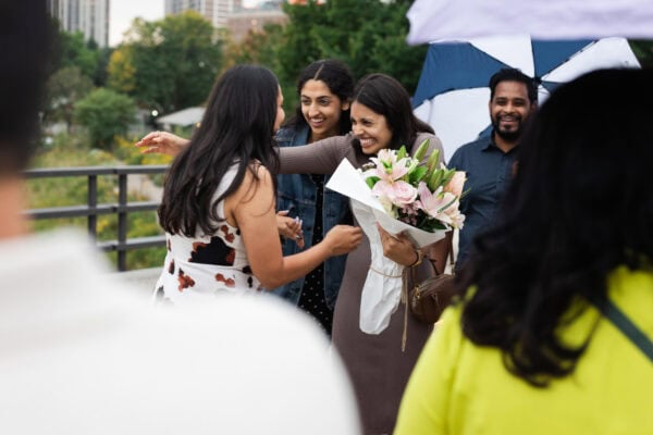 two friends embrace in celebration after one of them just got engaged