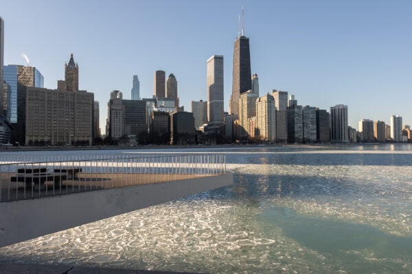 a landscape of the chicago skyline from Olive Park with pancake ice on the lake