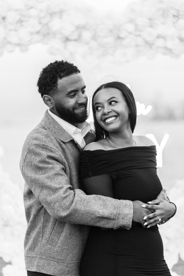 a newly engaged couple poses for a photo in Chicago at the lakefront at montrose harbor