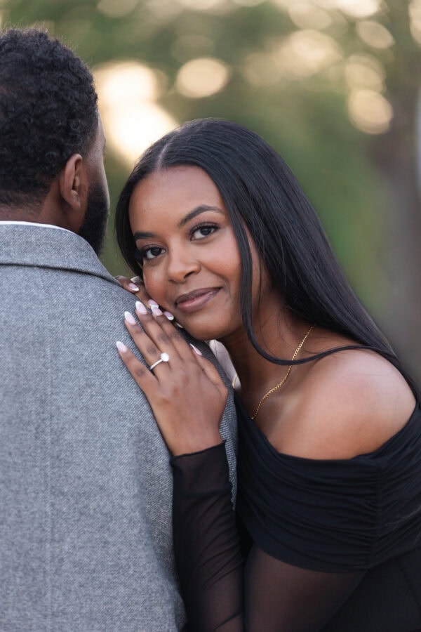 a newly engaged couple poses for a photo in Chicago at the lakefront at montrose harbor