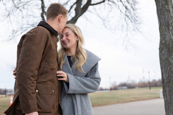 Engaged couple shares a romantic moment beneath trees at Olive Park after a Chicago proposal.